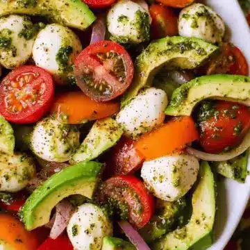 Tomato Cucumber Avocado Salad with Mozzarella and Basil Pesto